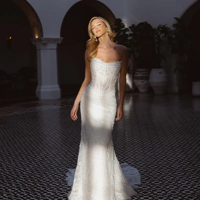 Bride wearing lace and sequin fit-and-flare wedding dress with corset
