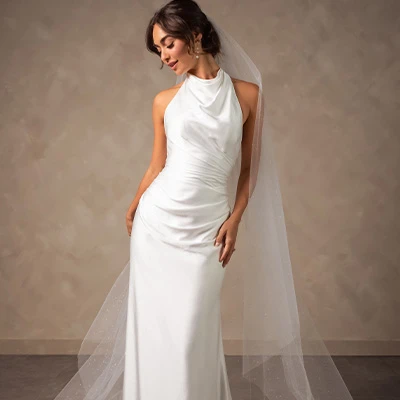 Bride wearing halter column sheath wedding dress with open back
