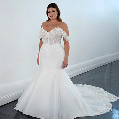 Bride wearing silk and lace fit-and-flare wedding dress with off-the-shoulder straps