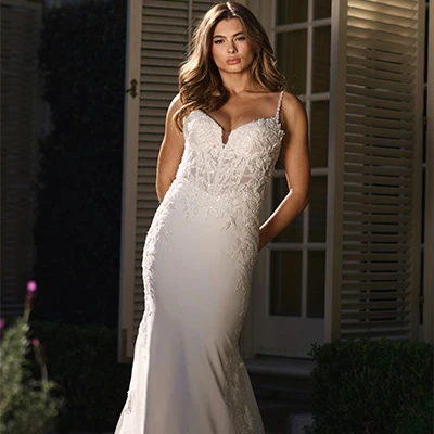 Bride wearing lace and crepe spaghetti strap wedding dress with sweetheart neck