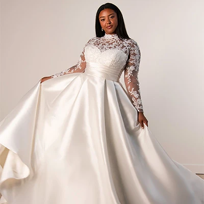 Bride wearing plus size a-line wedding dress with long sleeves and high neck