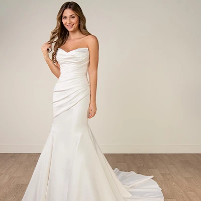 Bride wearing strapless mikado fit-and-flare wedding gown with ruching